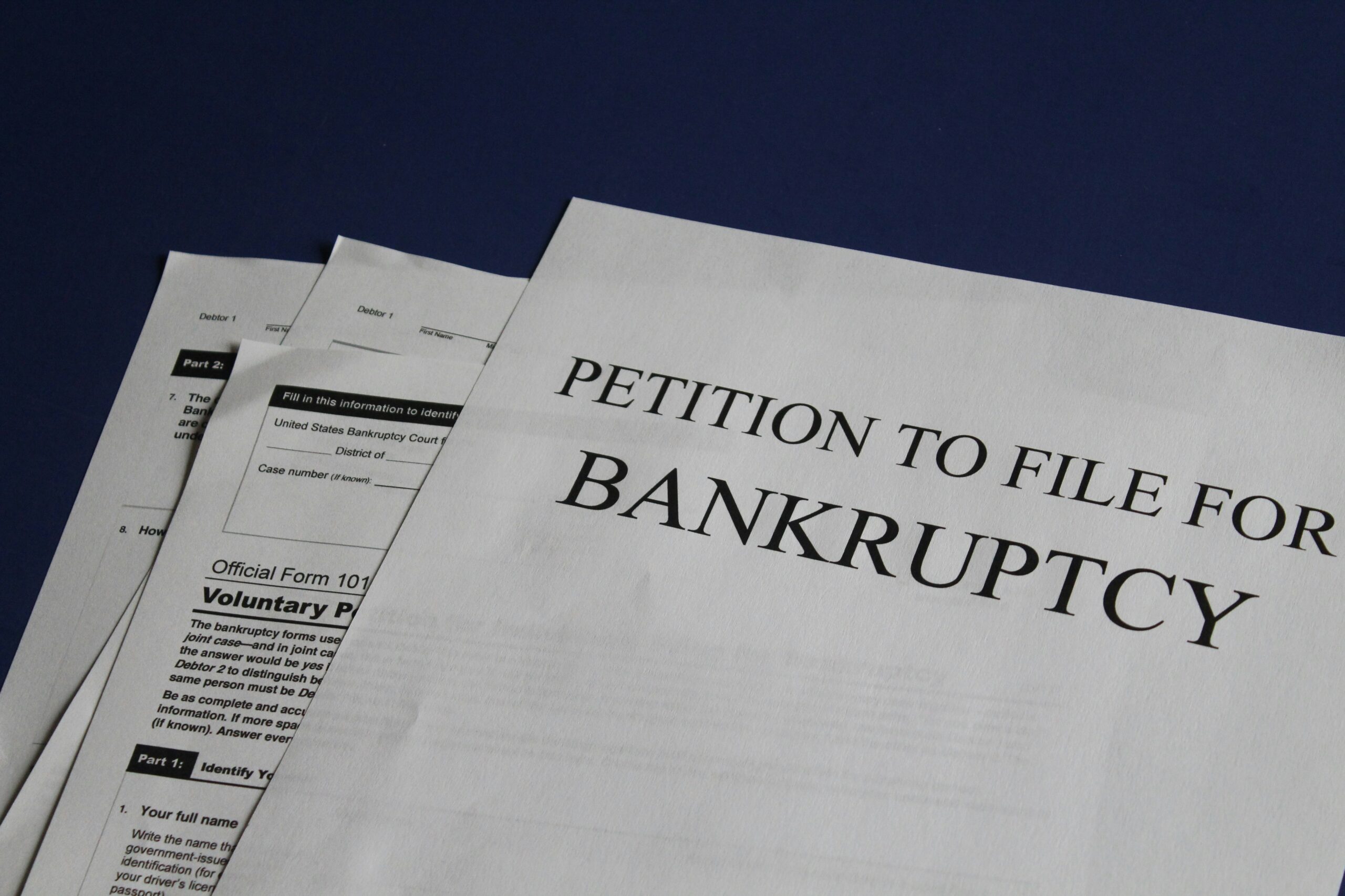 Papers that read "Petition for Bankrutpcy"