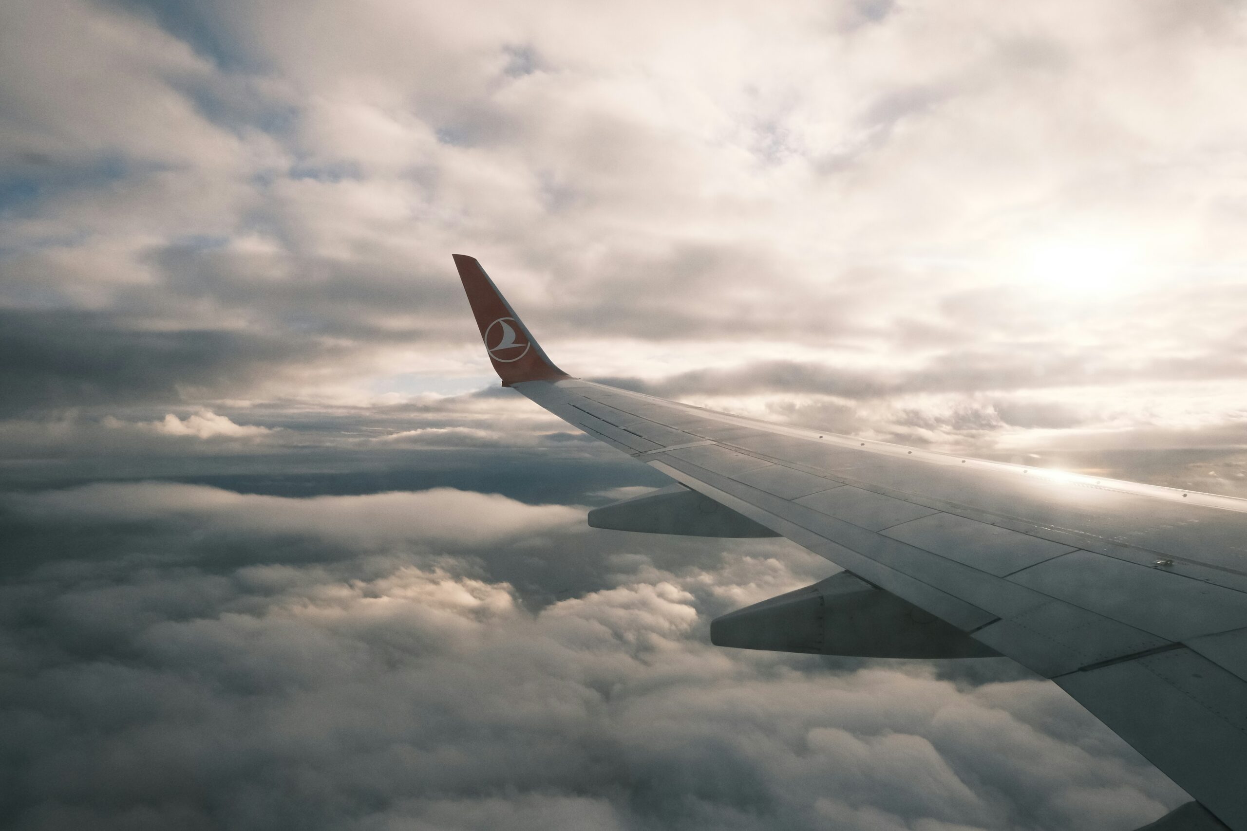 Clouds and the wing viewed from a Turkish Airlines airplane window