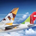Tails of Etihad aircraft and TAP Portugal aircraft.