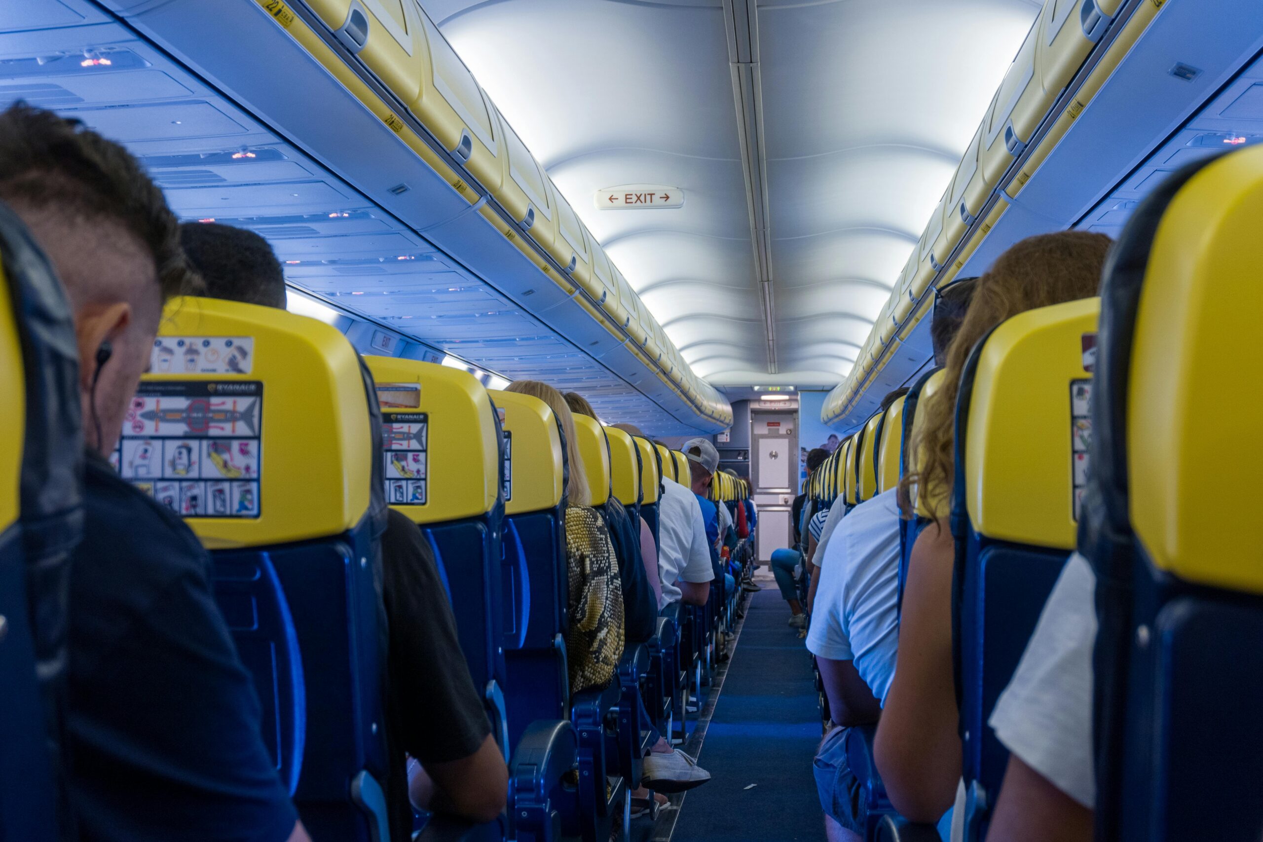 An image of the aisle of a Ryanair aircraft with passengers seated for takeoff