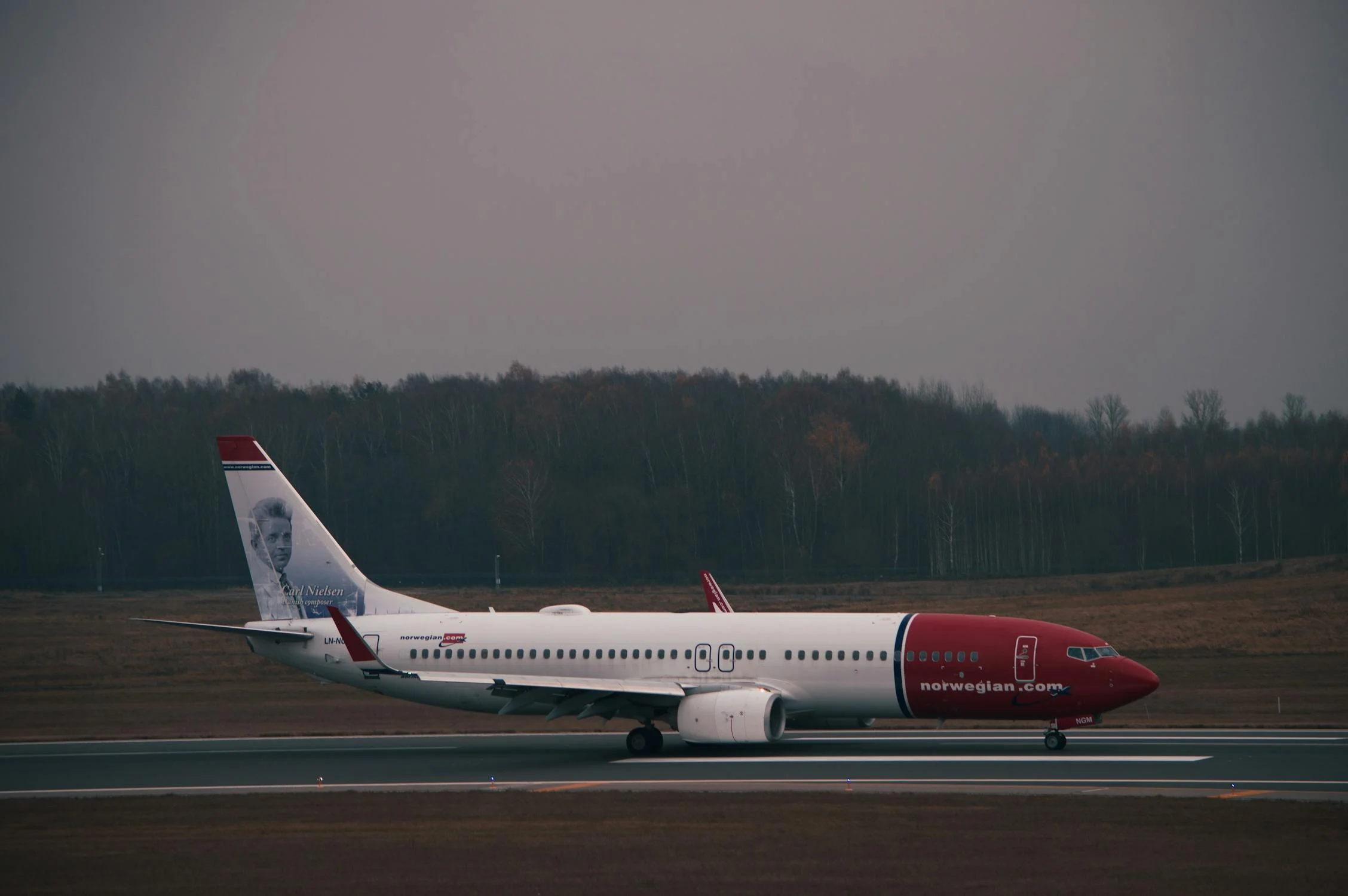 A photo of a Norwegian airplane taxiing