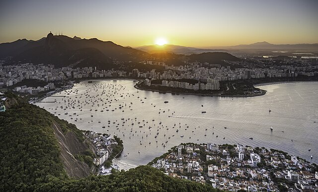 Overlooking the landscape, houses and water of Rio de Janeiro at sunset.