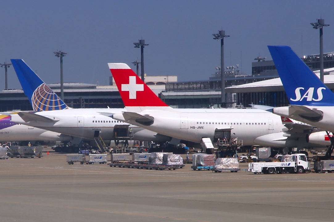 An image of Scandinavian Airlines, Swiss Airlines and United Airlines aircraft waiting at Tokyo Haneda Airport.