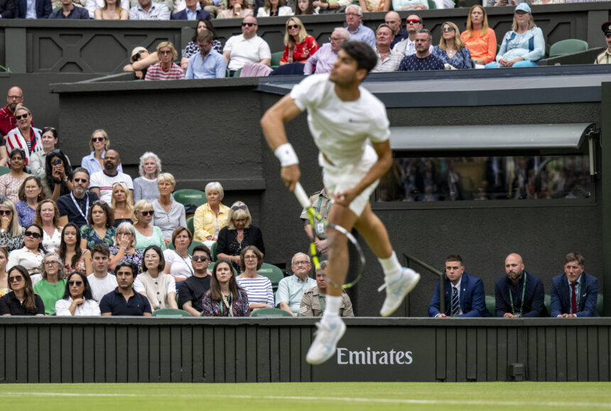 Emirates sponsorship behind Carlos Alcaraz (ESP) who serves against Frances Tiafoe (USA) in the third round of the Gentlemen's Singles on Centre Court at The Championships 2024