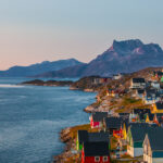 Colourful houses at sunset in the capital of Greenland, Nuuk. Mountain in the background and houses are at the right edge of the photo.