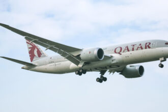 A Qatar Airways Boeing 787-8 (Dreamliner) in the air.
