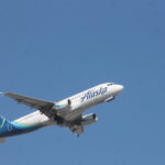 An image of an Alaska Airlines Airbus A320 taking off.