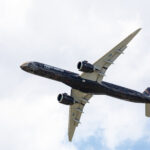 The underside of an airborne Embraer E195-E2 aircraft.
