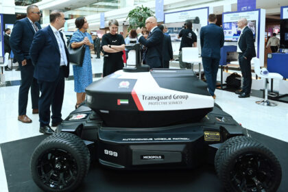 A robot stands on display at an event, highlighting advancements in robotics and technology.