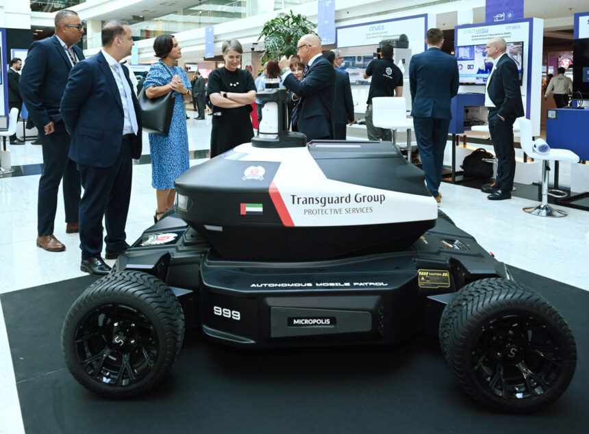 A robot stands on display at an event, highlighting advancements in robotics and technology.