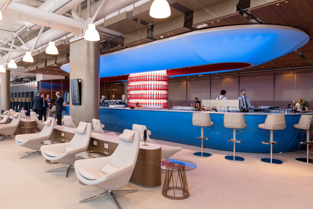 An upscale bar with decorative lighting and a colourful drink display.