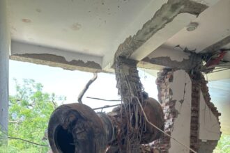 Aircraft's landing gear, inside the building along with the debris.