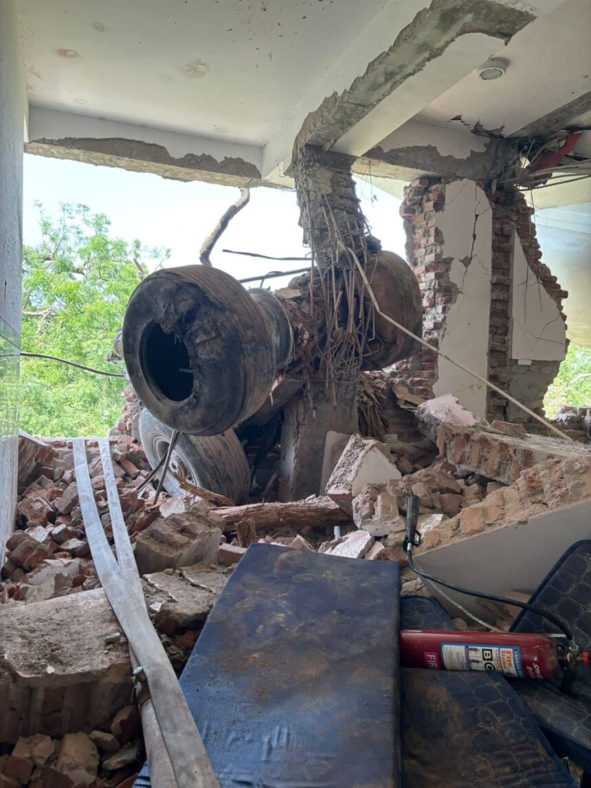 Aircraft's landing gear, inside the building along with the debris.