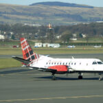An image of a Loganair aircraft at Glasgow Airport with its iconic tartan tail.