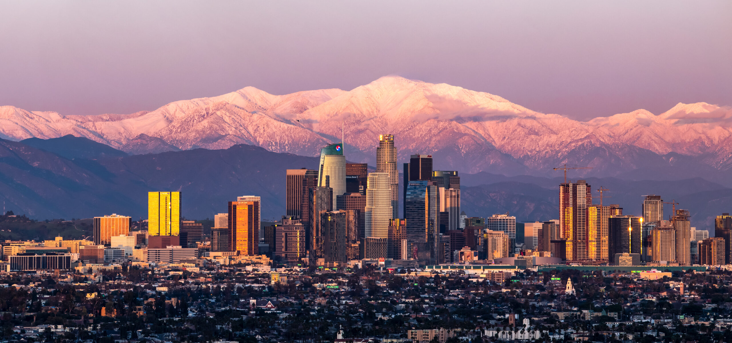 An image of Los Angeles' skyline with mountains in the background.