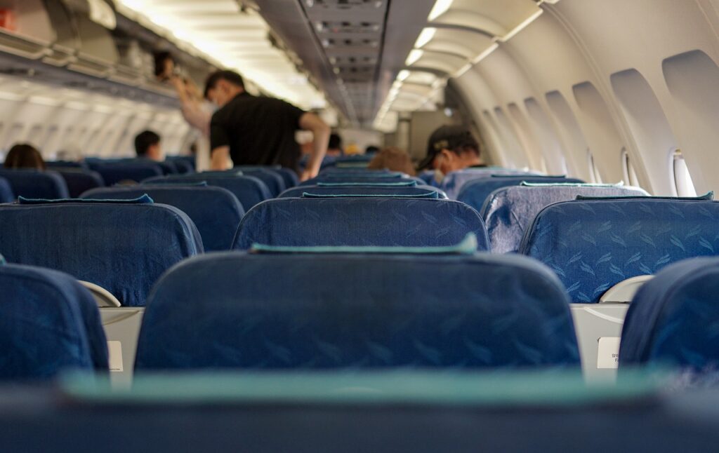 Travellers getting ready for a trip as they're boarding an aircraft. 