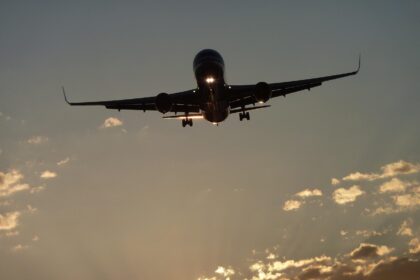 Boeing landing at sunset