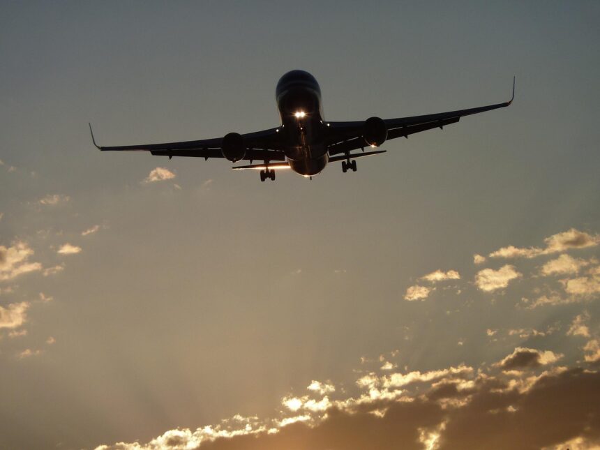Boeing landing at sunset