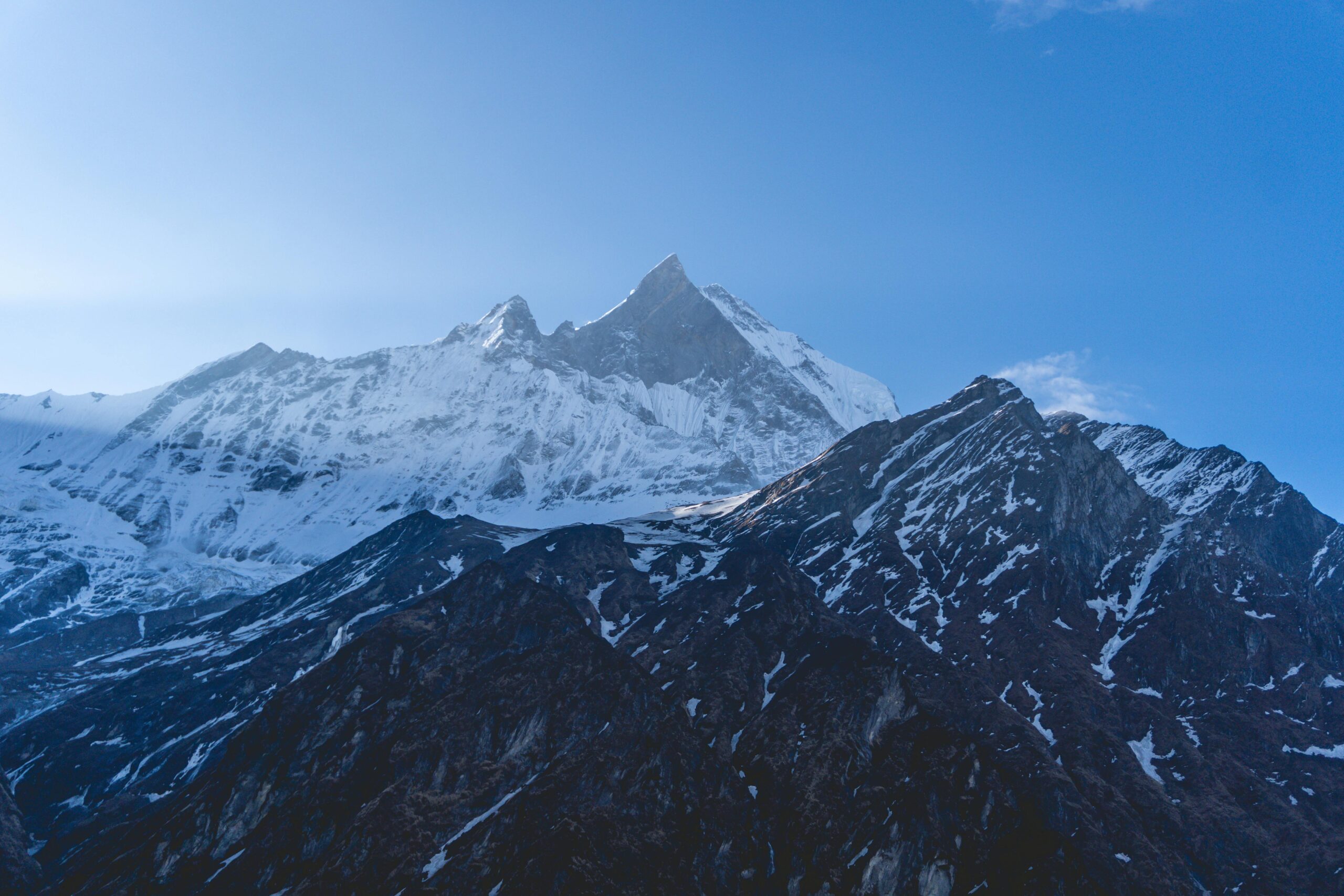 A mountain with snow on it and a blue sky