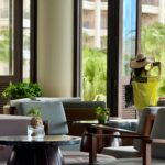 Woman Taking Photo in Tropical Resort Lounge