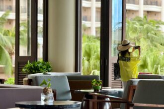 Woman Taking Photo in Tropical Resort Lounge