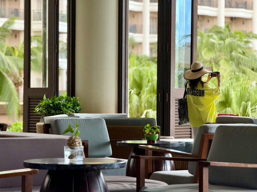 Woman Taking Photo in Tropical Resort Lounge