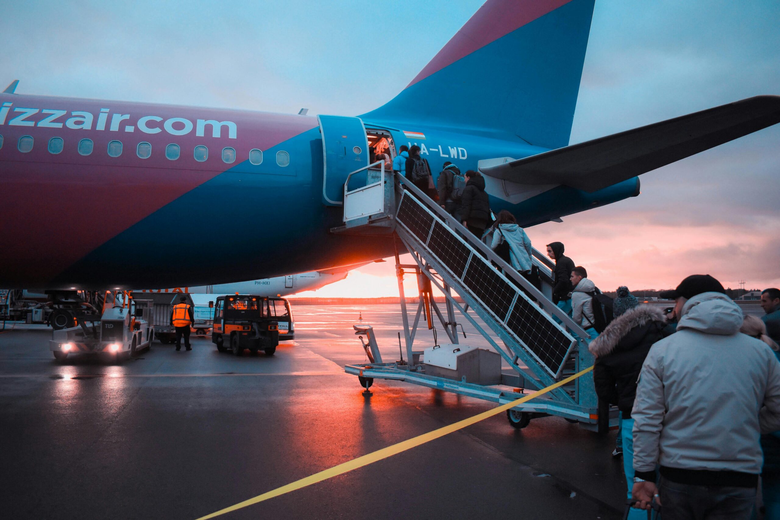 Photo of People Boarding Airliner during sunset