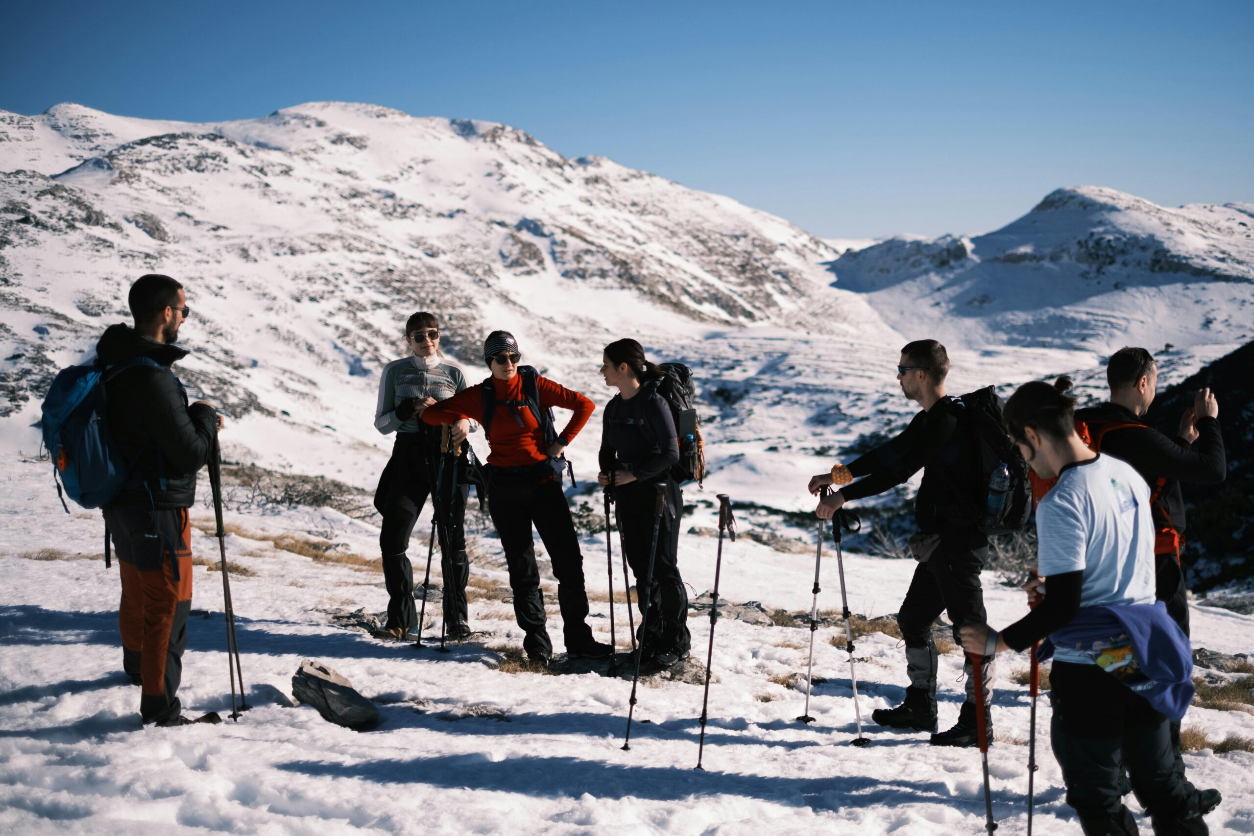 Group of Hikers Trekking Through Snowy Mountains