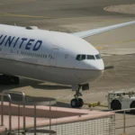 A photo of a United Airline being towed on runway