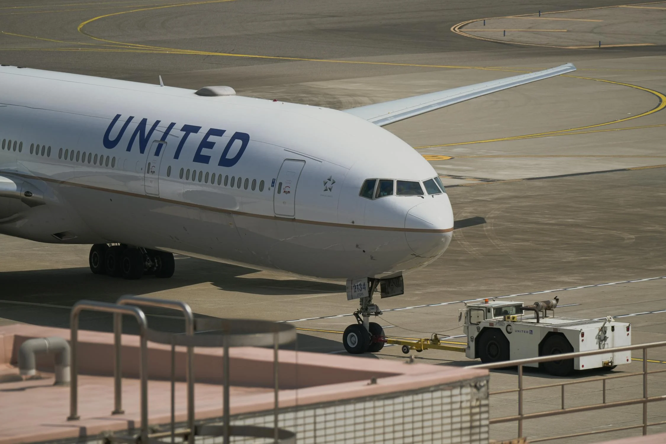 A photo of a United Airline airlane Being Towed on Runway 