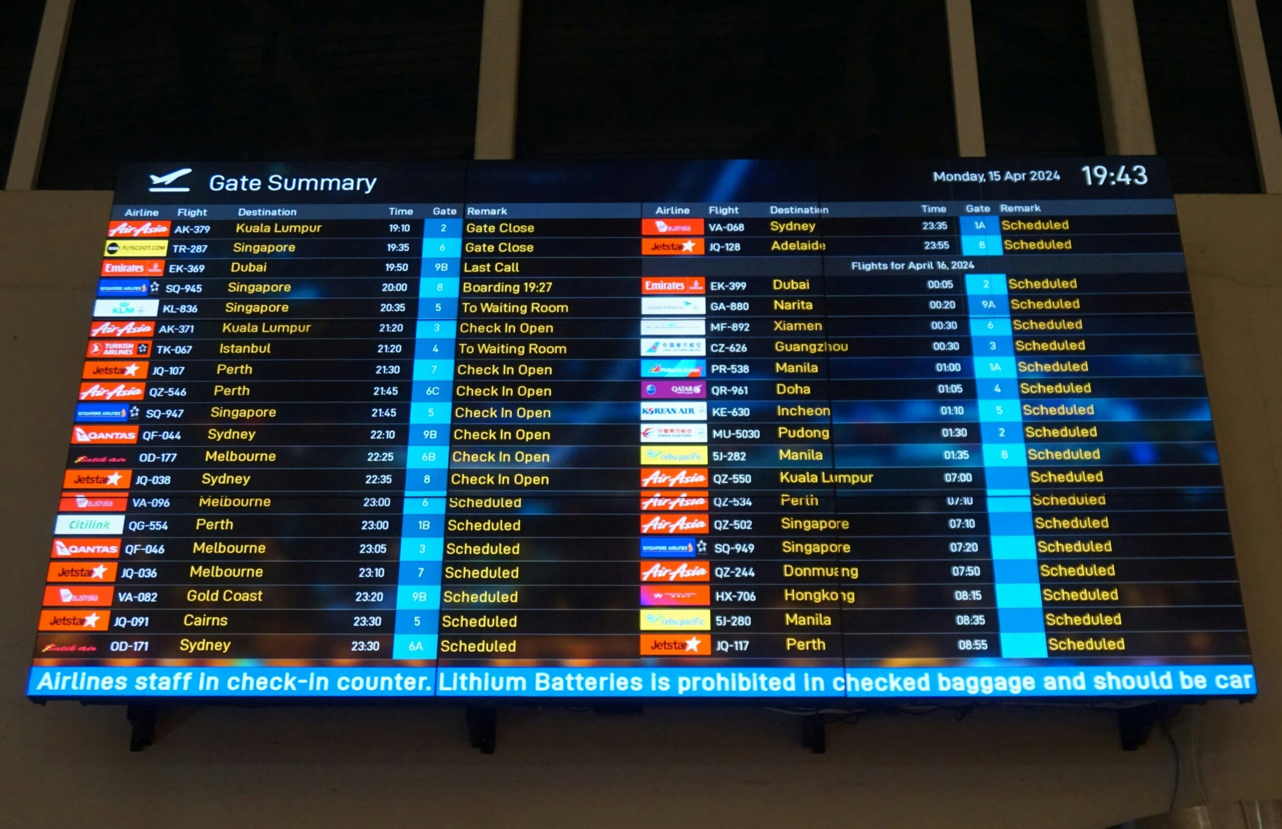 A large digital screen displaying current flight information, including arrivals and departures at an airport.
