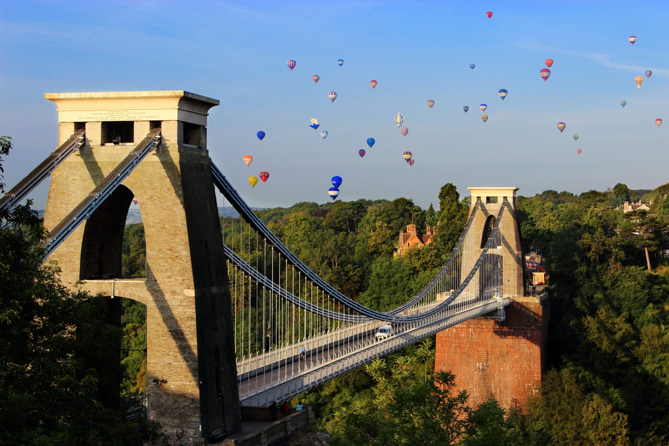 Many hot air balloons fly over the Clifton Suspension Bridge, which sits over the Avon Gorge in Bristol.