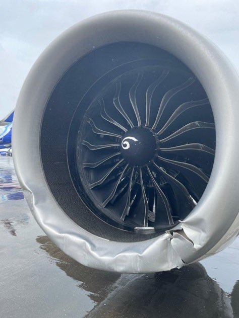 An image of the plane's right engine. The lip of the engine is damaged after being dragged across the ground.