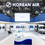 Exhibition booth for Korean Air showcasing Smart Drone technology. Features a drone on a platform, screens with data, and a model aeroplane.