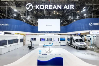Exhibition booth for Korean Air showcasing Smart Drone technology. Features a drone on a platform, screens with data, and a model aeroplane.