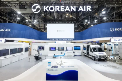 Exhibition booth for Korean Air showcasing Smart Drone technology. Features a drone on a platform, screens with data, and a model aeroplane.