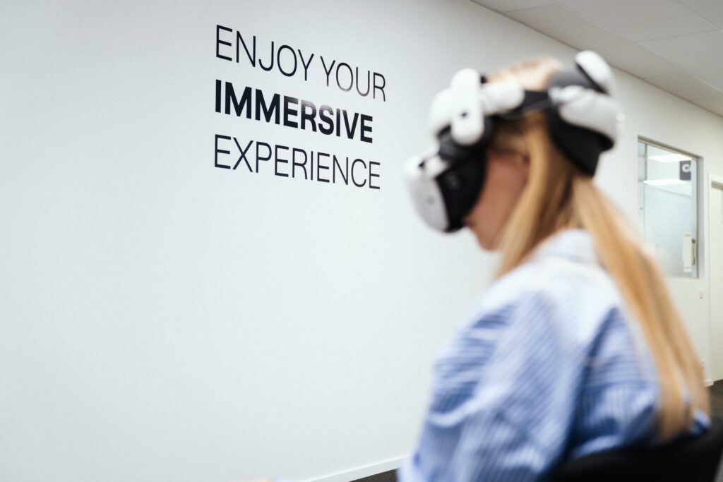 A woman using a VR headset, with the words "Enjoy your immersive experience" visible in the background.