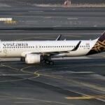 An Airbus A320 with Vistara livery, on the tarmac at Dubai Airport.