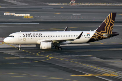 An Airbus A320 with Vistara livery, on the tarmac at Dubai Airport.