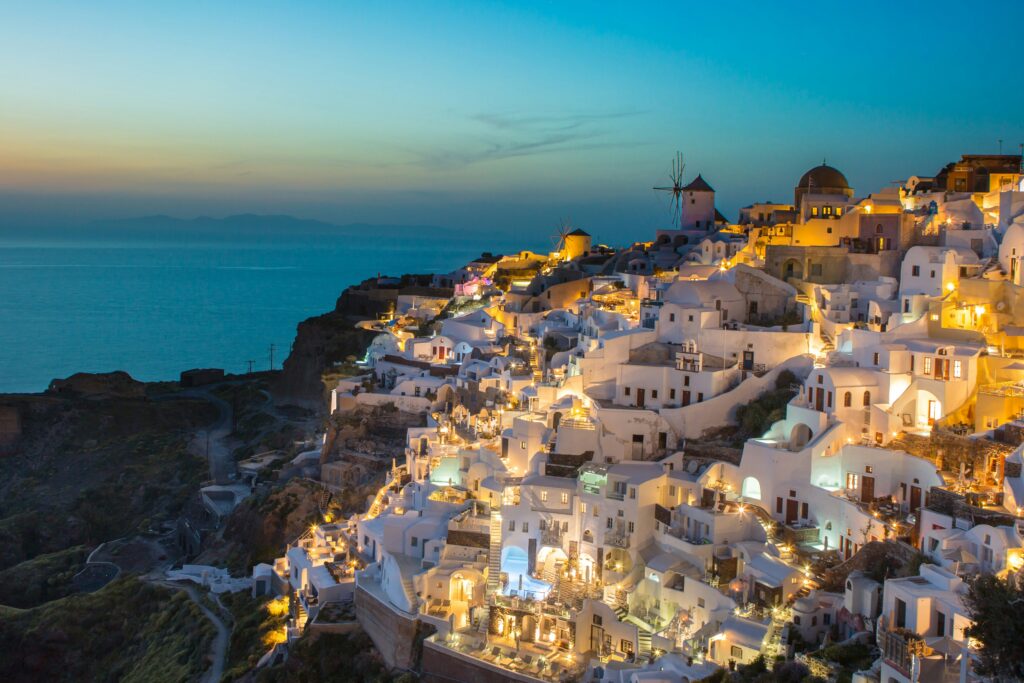 Scenic Oia village in Santorini, Greece, featuring iconic white buildings and stunning views of the Aegean Sea.