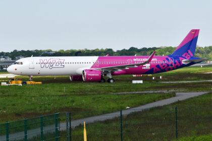 An Airbus A321-271NX of WizzAir Abu Dhabi on the ground at an airport.