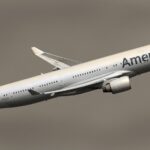 American Airlines aircraft taking off against a dark sky.