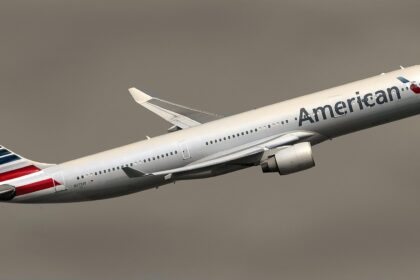 American Airlines aircraft taking off against a dark sky.