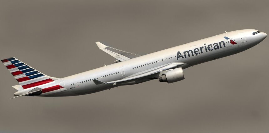 American Airlines aircraft taking off against a dark sky.