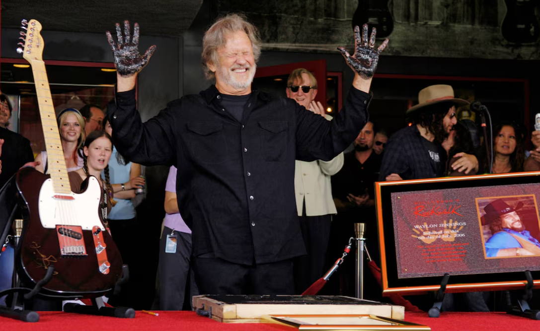  Singer-songwriter Kris Kristofferson holds his hands out to dry after putting them in cement at a Hollywood RockWalk induction ceremony in Los Angeles, July 6, 2006. Kristofferson was inducted along with late country singer Waylon Jennings, seen in the picture at right. © Chris Pizzello