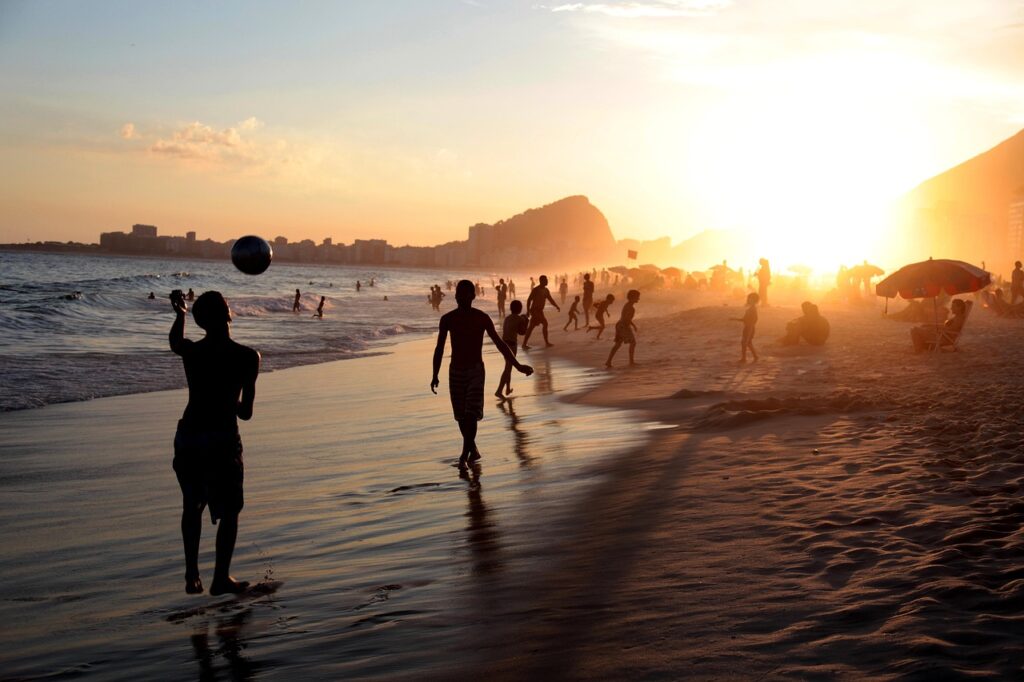 People on a beach with a sunset in the background