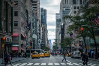 A busy street in New York with people crossing the road and traffic in the background