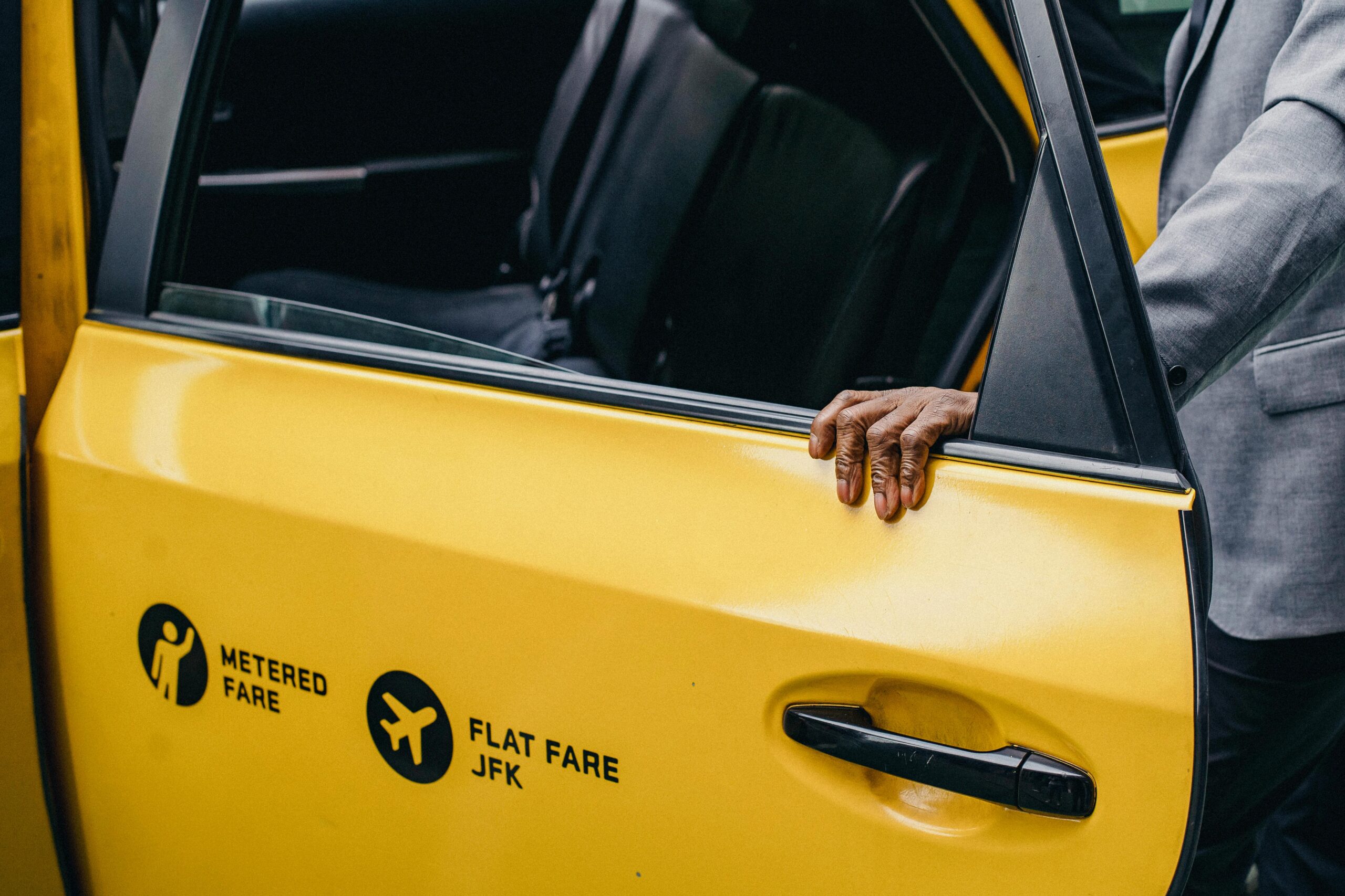 An open door of a yellow cab at JFK in New York