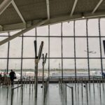 London Heathrow Airport (LHR) interior view, windows showing outside.