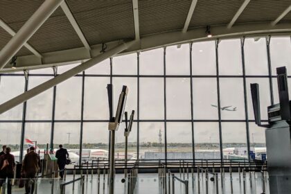 London Heathrow Airport (LHR) interior view, windows showing outside.